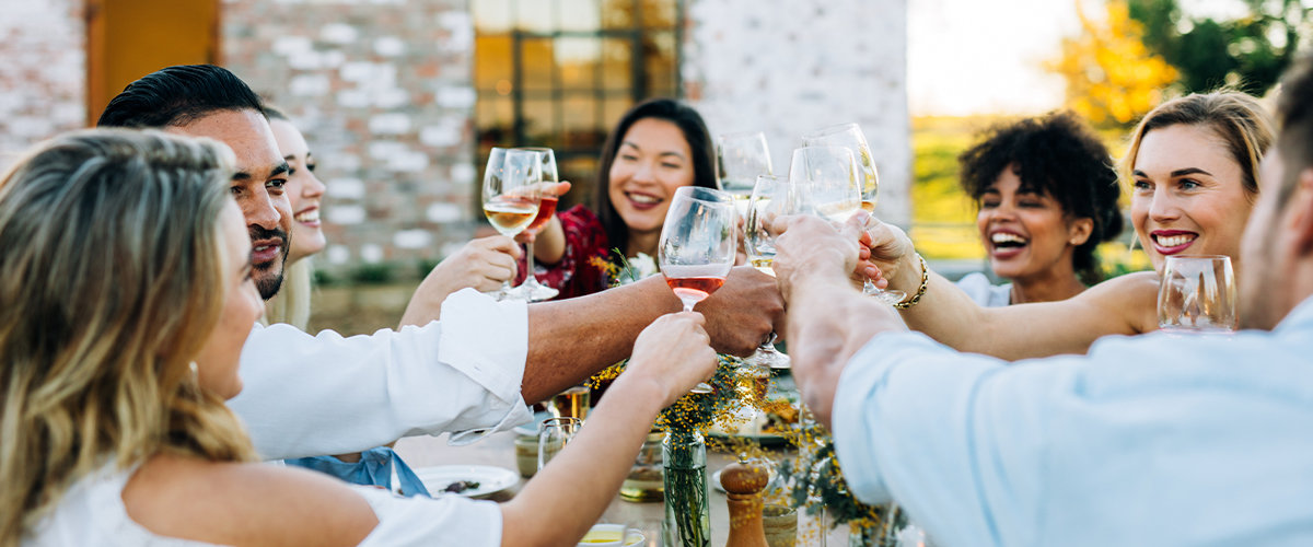 Friends cheers at backyard dinner party
